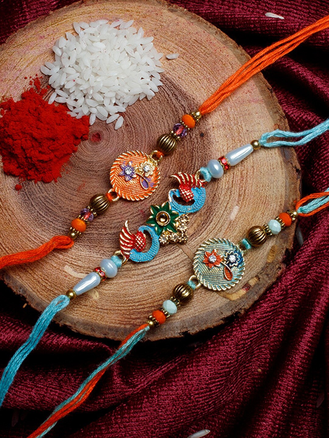 

Shoshaa Men Set Of 3 Orange & Turquoise Blue Stone-Studded & Beaded Peacock Thread Rakhi With Roli & Chawal