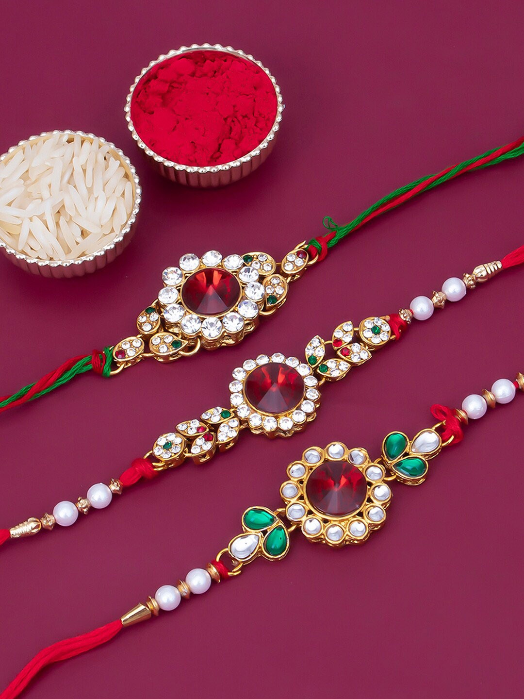 

Sukkhi Rakhi Men Set Of 3 Gold-Plated White & Red Stone-Studded Beaded Rakhi With Roli Chawal & Greeting Card