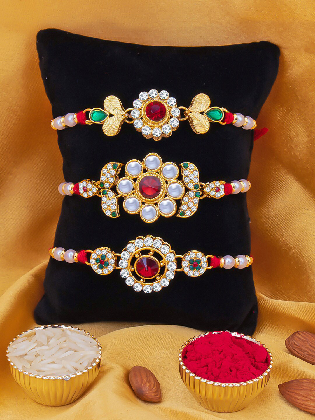 

Sukkhi Rakhi Men Set Of 3 Gold-Plated & Red Thread Rakhi With Roli Chawal & Greeting Card