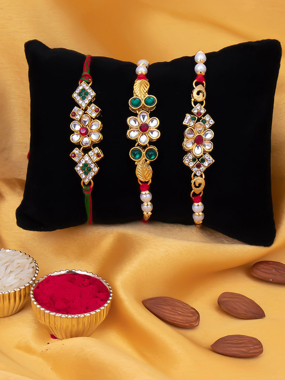 

Sukkhi Rakhi Men Set Of 3 Gold-Plated White & Red Stone-Studded & White Beaded Rakhi With Roli Chawal & Greeting Card