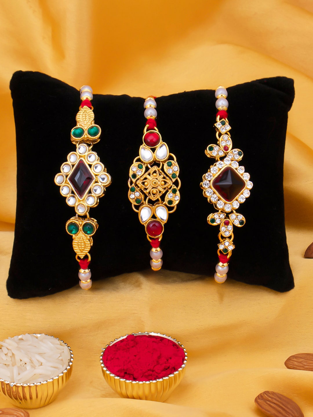 

Sukkhi Rakhi Men Set Of 3 Gold-Plated White & Red Stone-Studded & White Beaded Rakhi With Roli Chawal & Greeting Card