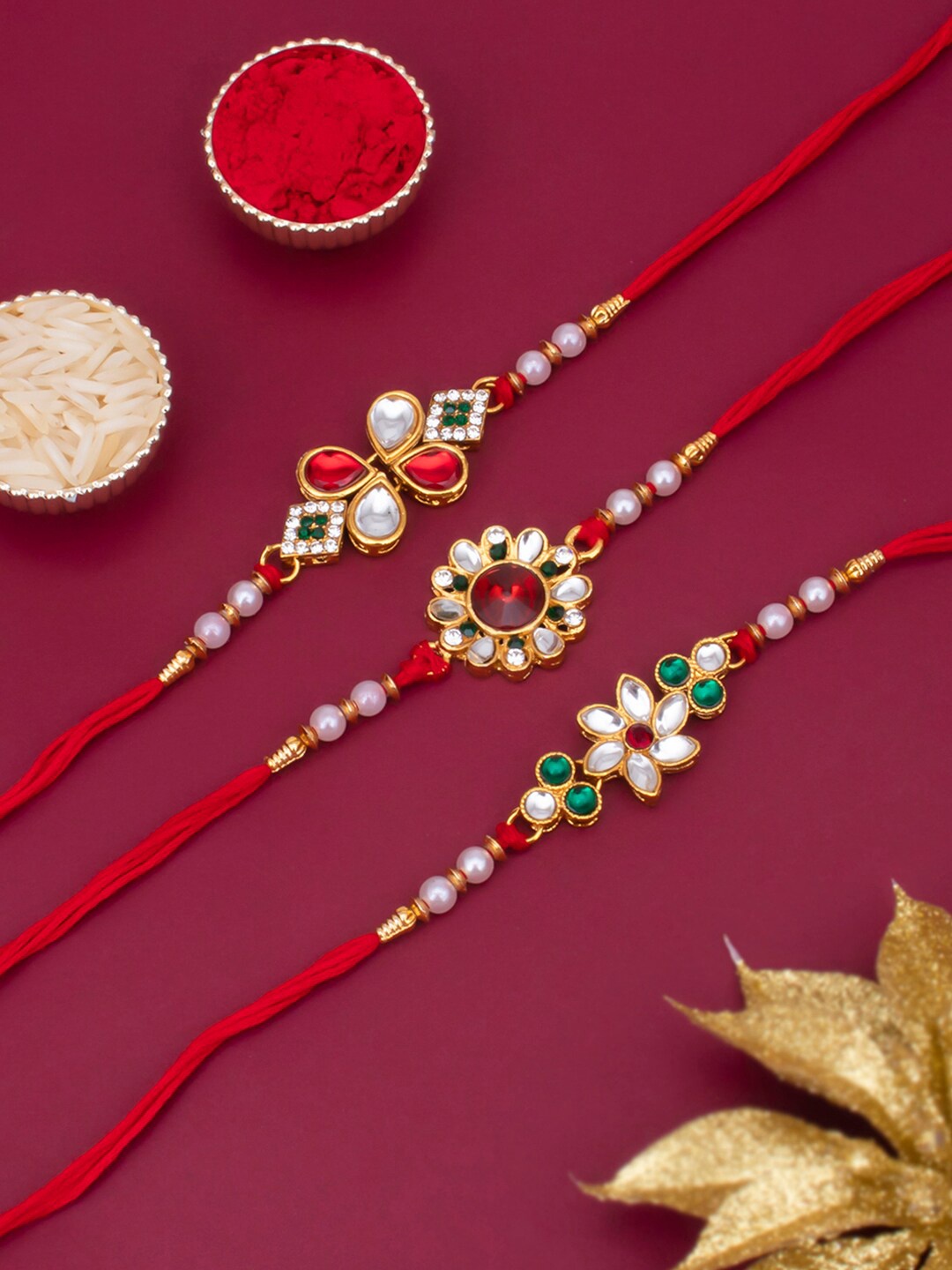 

Sukkhi Rakhi Men Set Of 3 Gold-Toned White & Red Stone Rakhi With Roli Chawal & Greeting Card