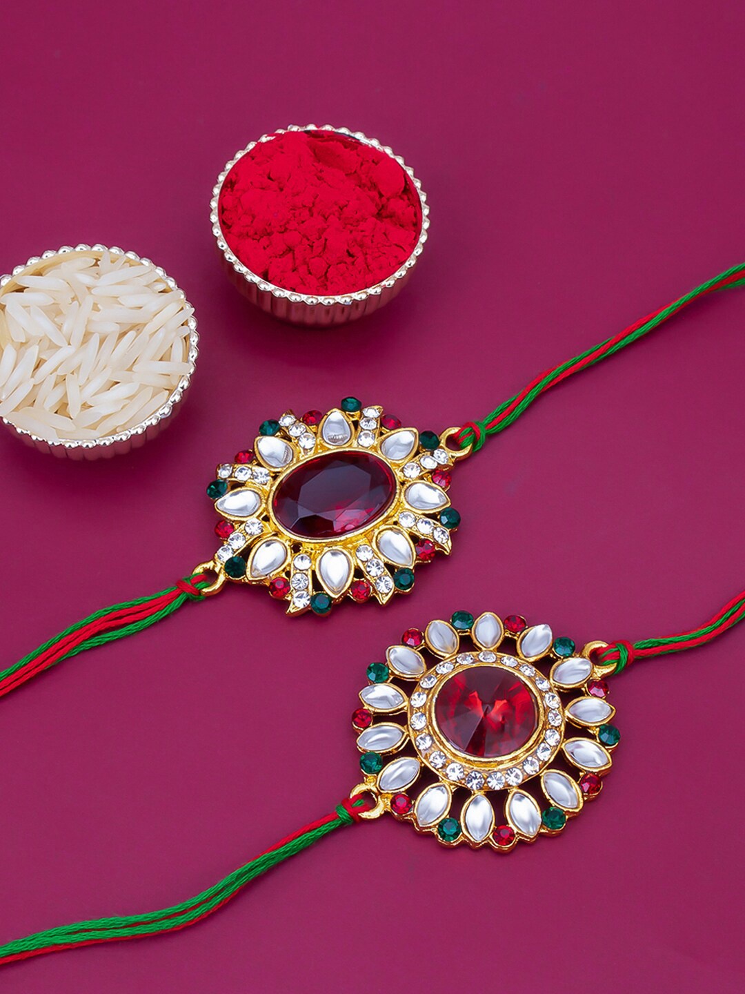 

Sukkhi Rakhi Unisex Set Of 2 Gold-Plated & Red Thread Rakhi With Roli Chawal & Greeting Card