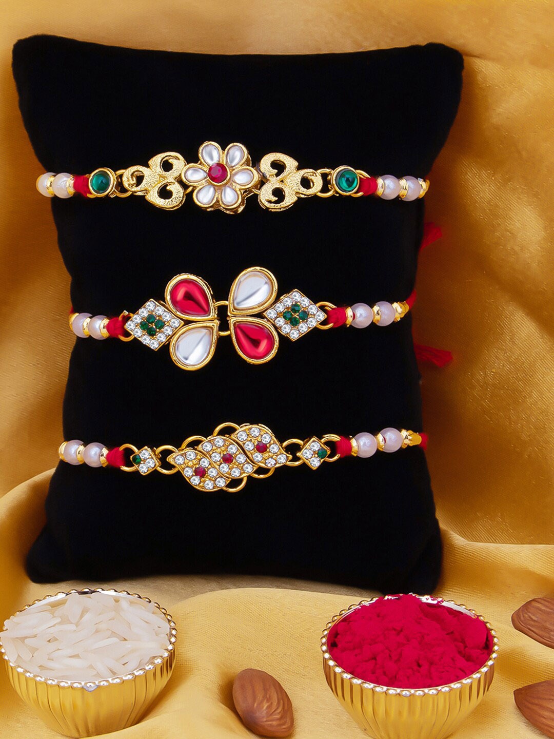 

Sukkhi Rakhi Men Set Of 3 Gold-Toned White & Red Stone Rakhi With Roli Chawal & Greeting Card