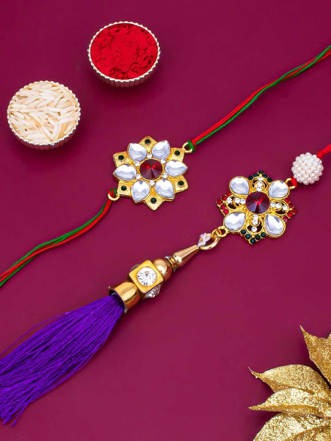 

Sukkhi Rakhi Unisex Gold-Plated Bhaiya Bhabhi Rakhi Lumba Set With Roli Chawal & Greeting Card, Red
