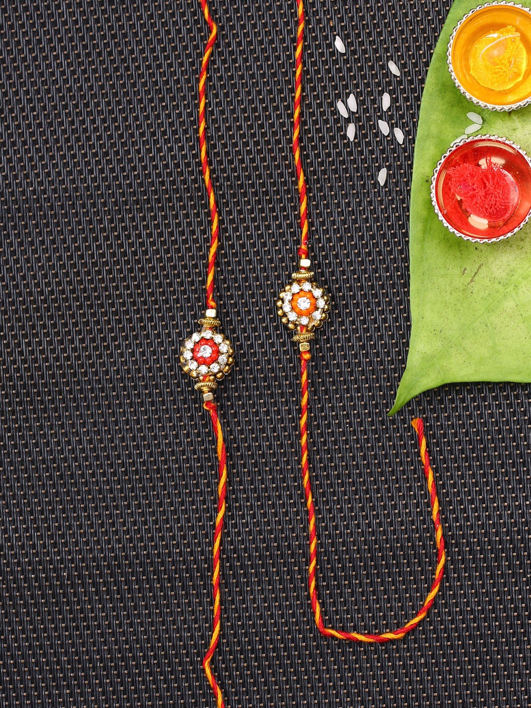 

Aapno Rajasthan Red & Orange Set Of 2 Flower Shape Handcrafted Bhaiya Rakhi