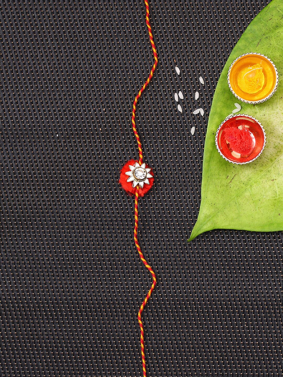 

Aapno Rajasthan Red Stone Embellished Handcrafted Mauli Rakhi