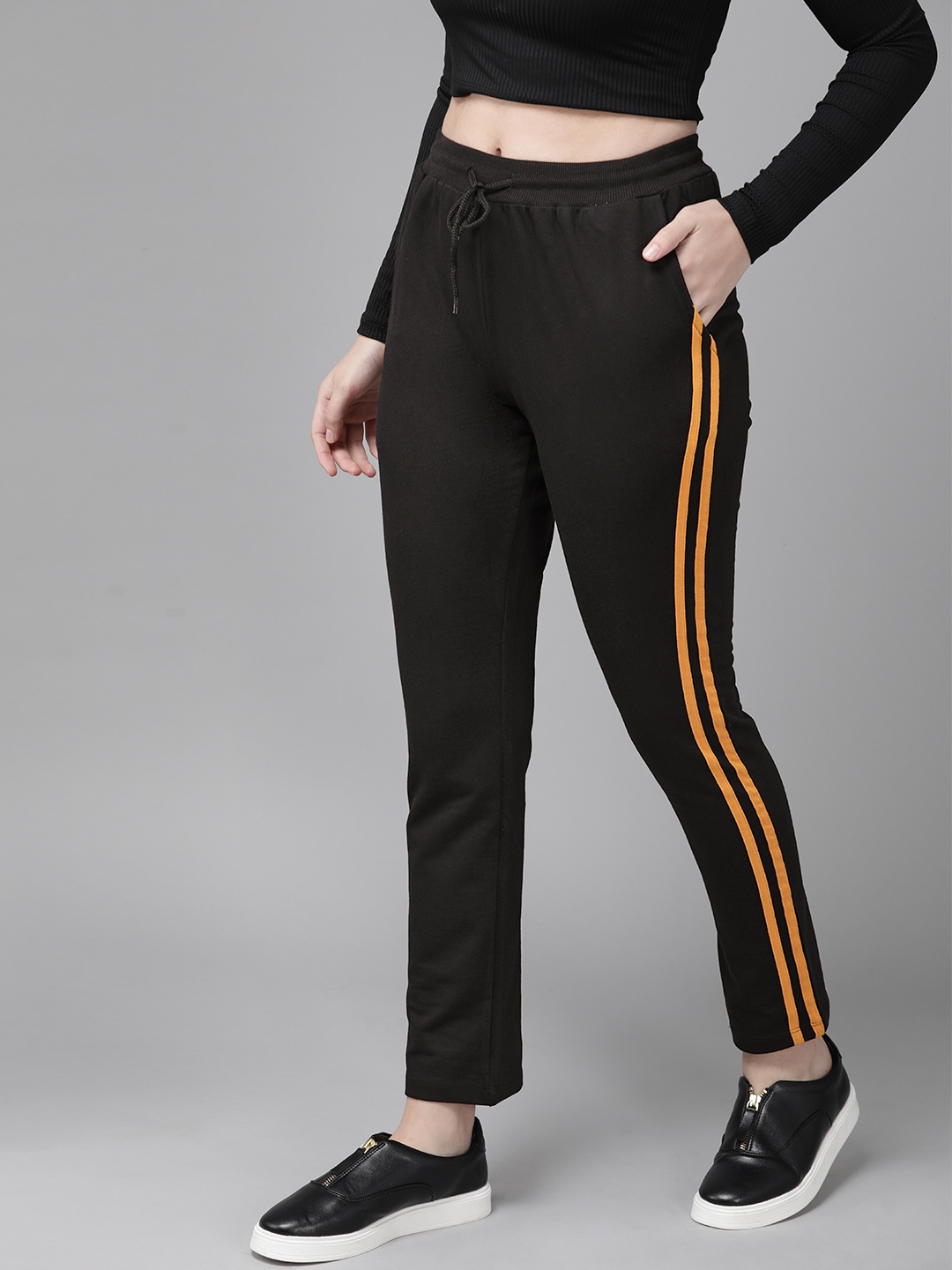 

Roadster Women Black Solid Cotton track Pants with Side Striped Detail