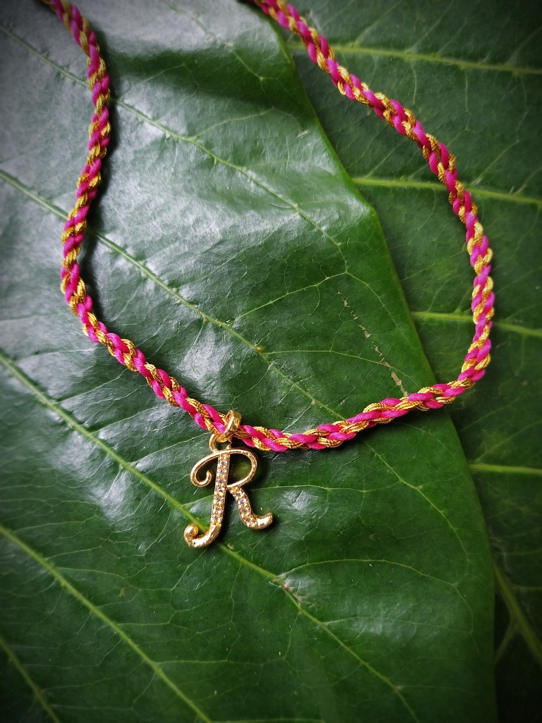 

Digital Dress Room Men Gold-Plated White & Pink AD-Studded R Alphabet Customized Pendant Thread Rakhi