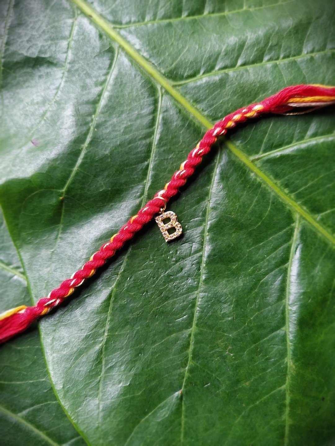 

Digital Dress Room Men Gold-Plated Red AD-Studded B Alphabet Customized Thread Rakhi