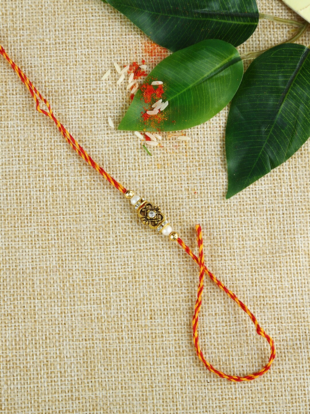 

Aapno Rajasthan Red & Gold-Toned Traditional Golden Bead Handcrafted Mauli Rakhi