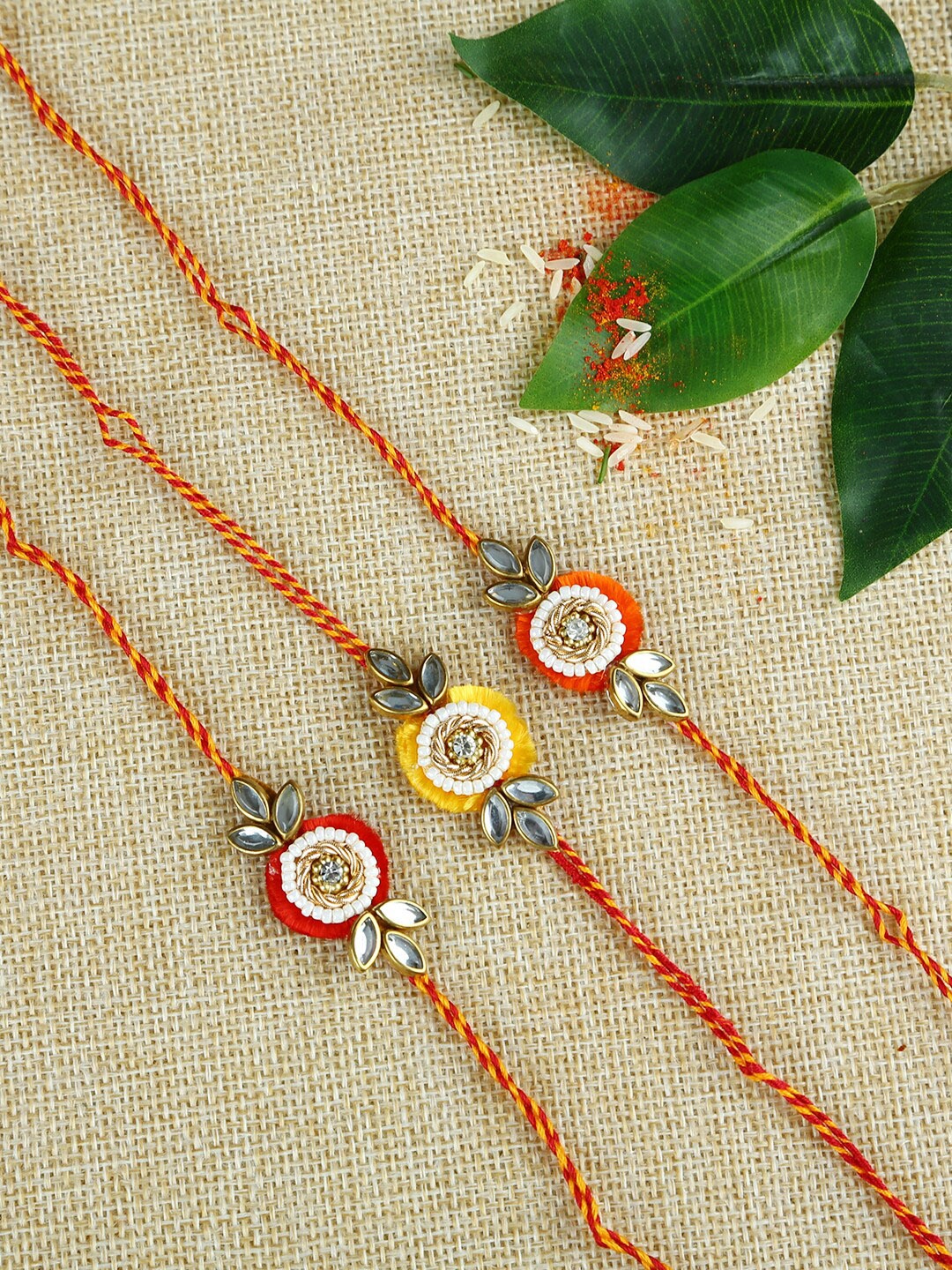 

Aapno Rajasthan Red & Yellow Set of 3 Handcrafted Kundan Rakhis