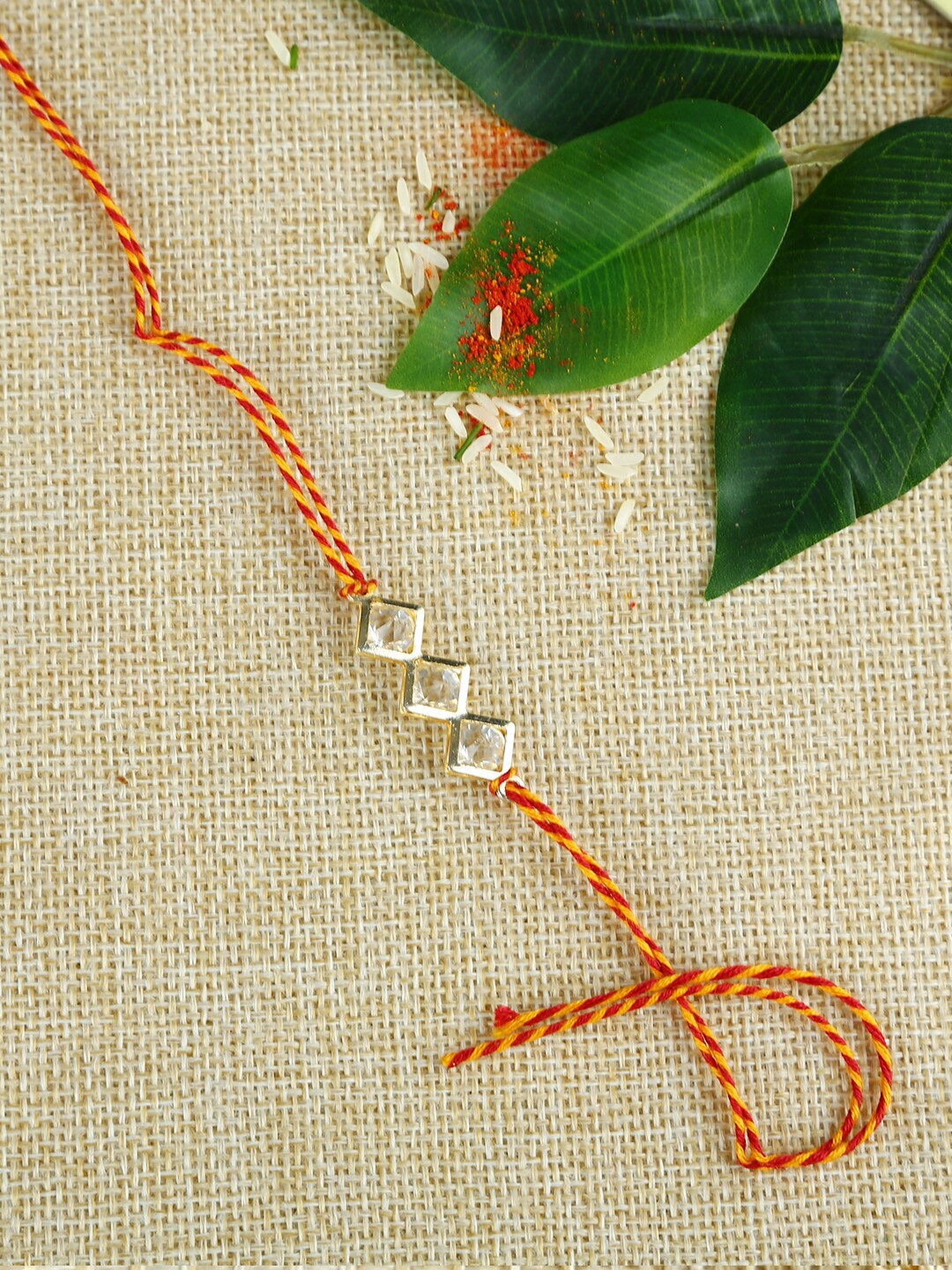 

Aapno Rajasthan Red & Yellow Handcrafted Diamond Beads Mauli Rakhi