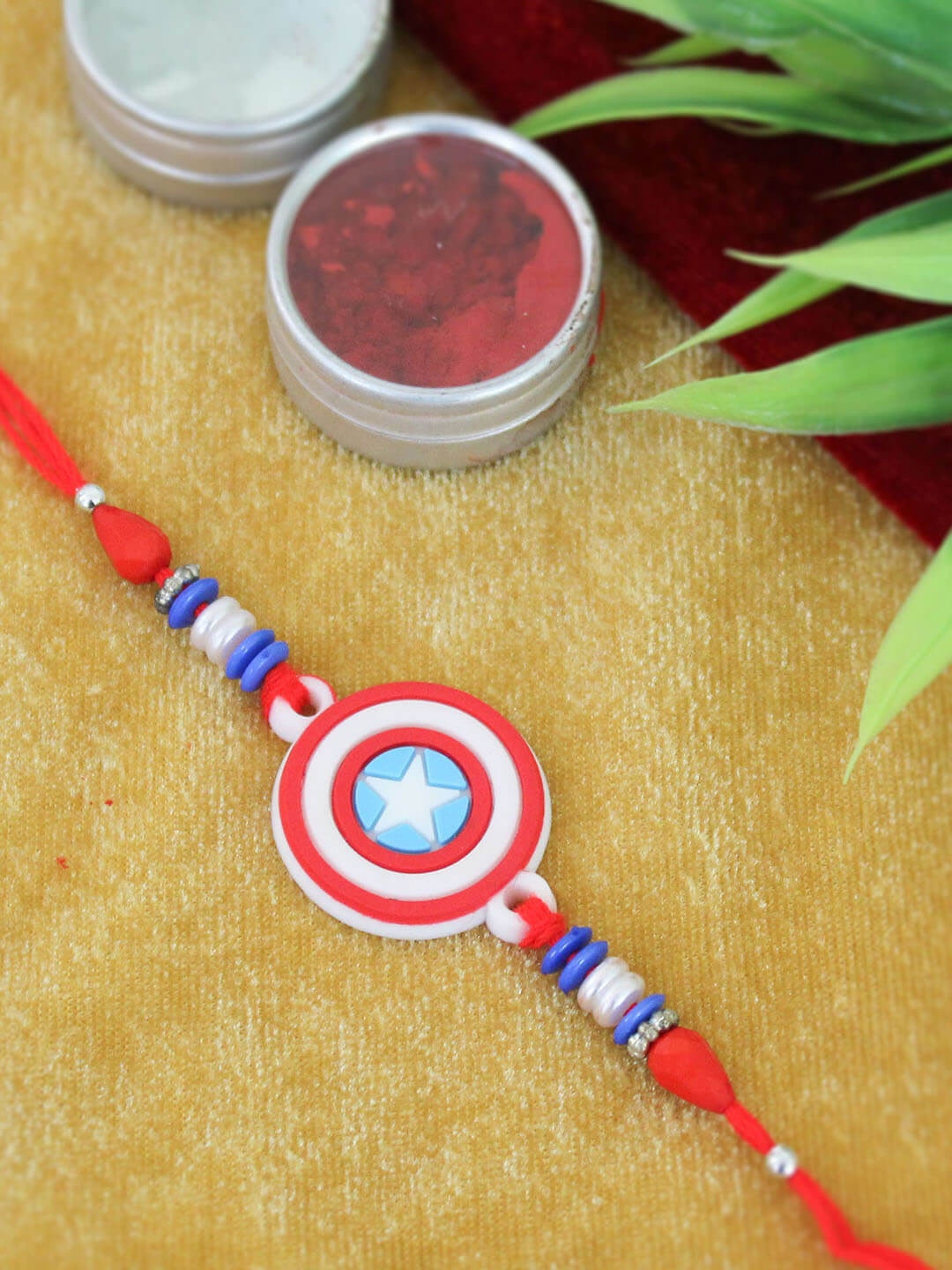 

TIED RIBBONS Boys Kids Red & Blue Captain America Rakhi with Card & Roli Chawal