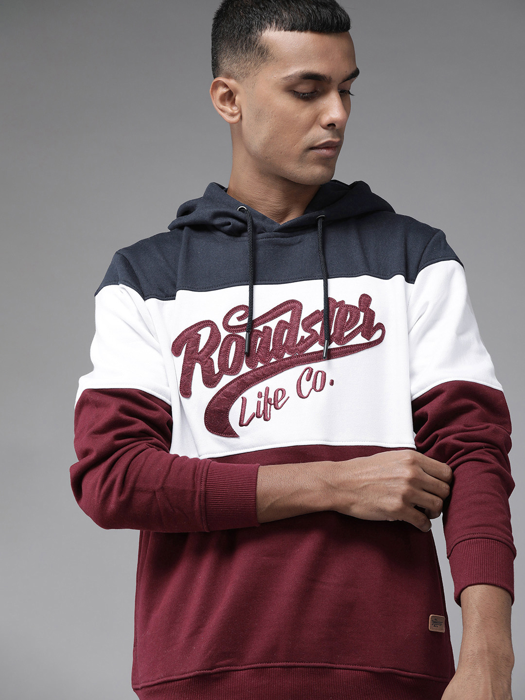 

Roadster Men Navy Blue Colourblocked Brand Logo Printed Hooded Sweatshirt