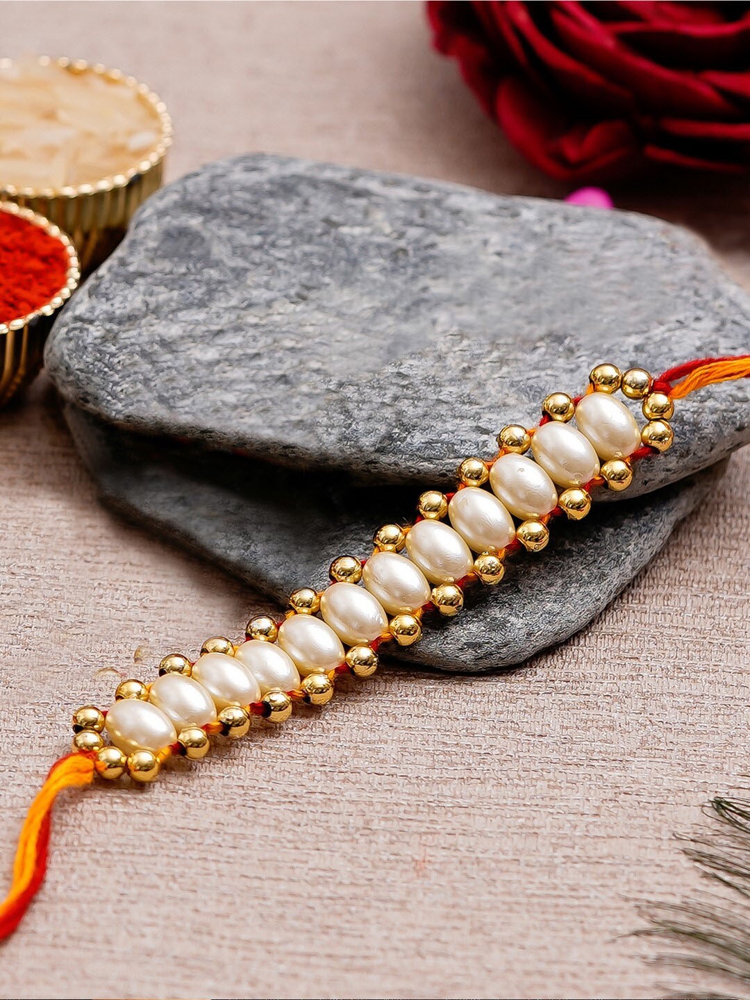 

eCraftIndia White & Gold-Toned Desinger Rakhi and Roli Chawal Set