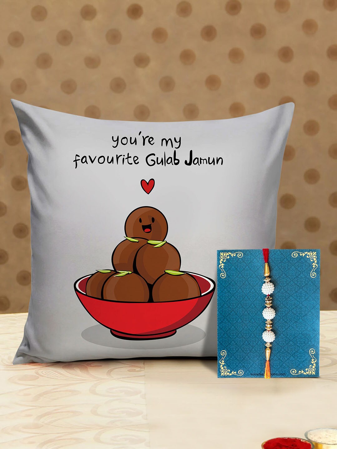 

TIED RIBBONS Multicoloured Designer Rakhi with Printed Cushion & Roli Chawal Gift Pack, Multi