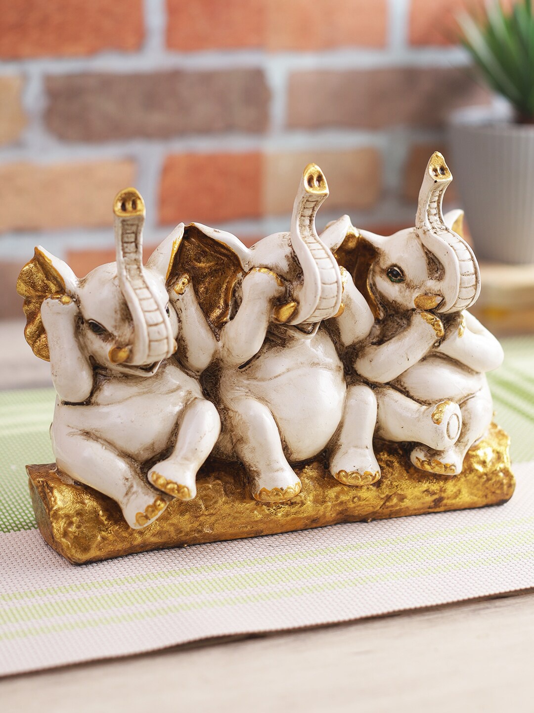 

CraftVatika Beige & Gold-Toned Elephant Trunk Up Showpiece