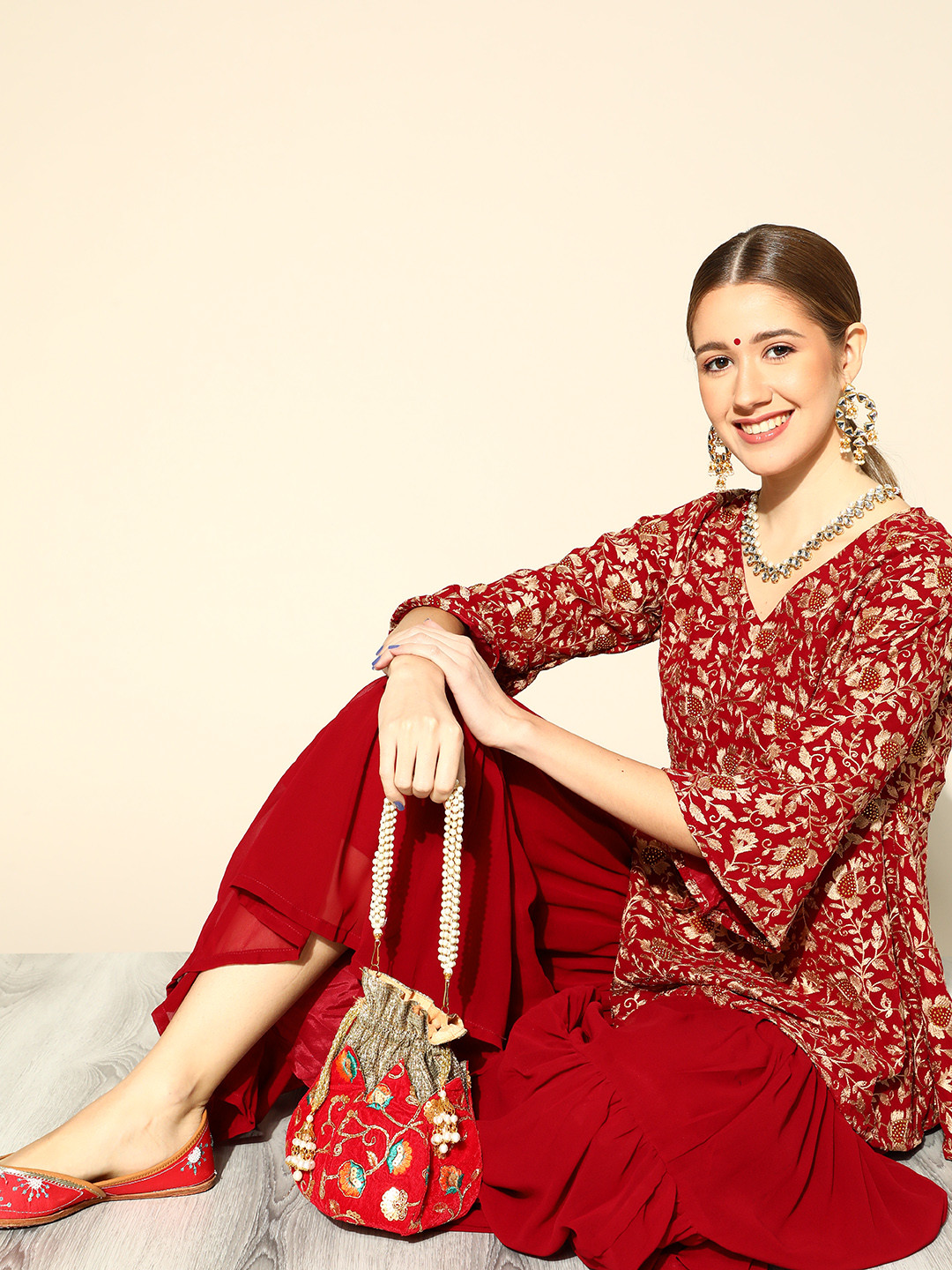 

Libas Women Maroon & Golden Floral Embroidered Panelled Peplum Kurti with Sharara