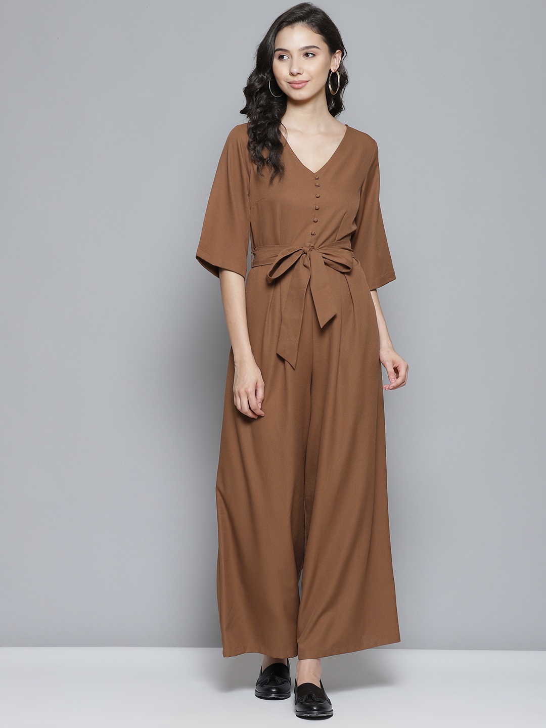 

Femella Women Brown Solid Flared Jumpsuit with Belt