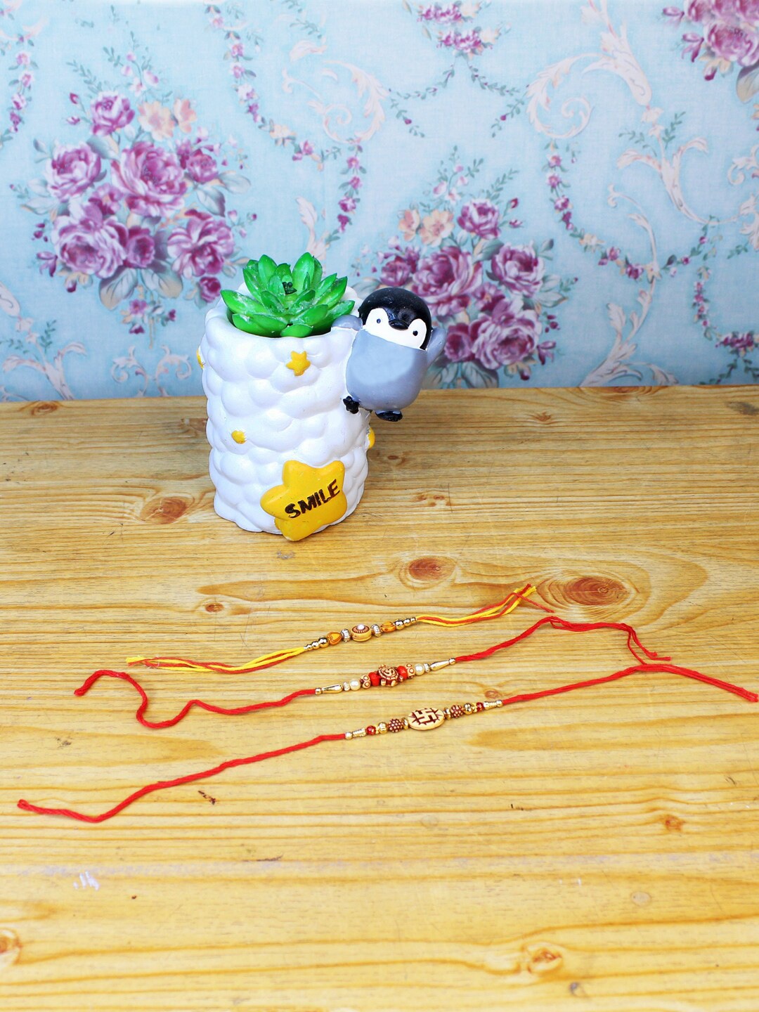 

Wonderland White & Red Set Of 3 Rakhi With Baby Penguin Succulent Planter