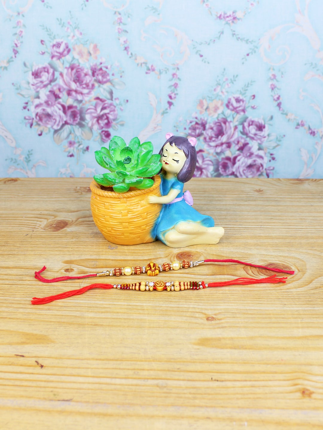 

Wonderland Orange & Red Set Of 2 Rakhi With Girl with Basket Succulent Planter