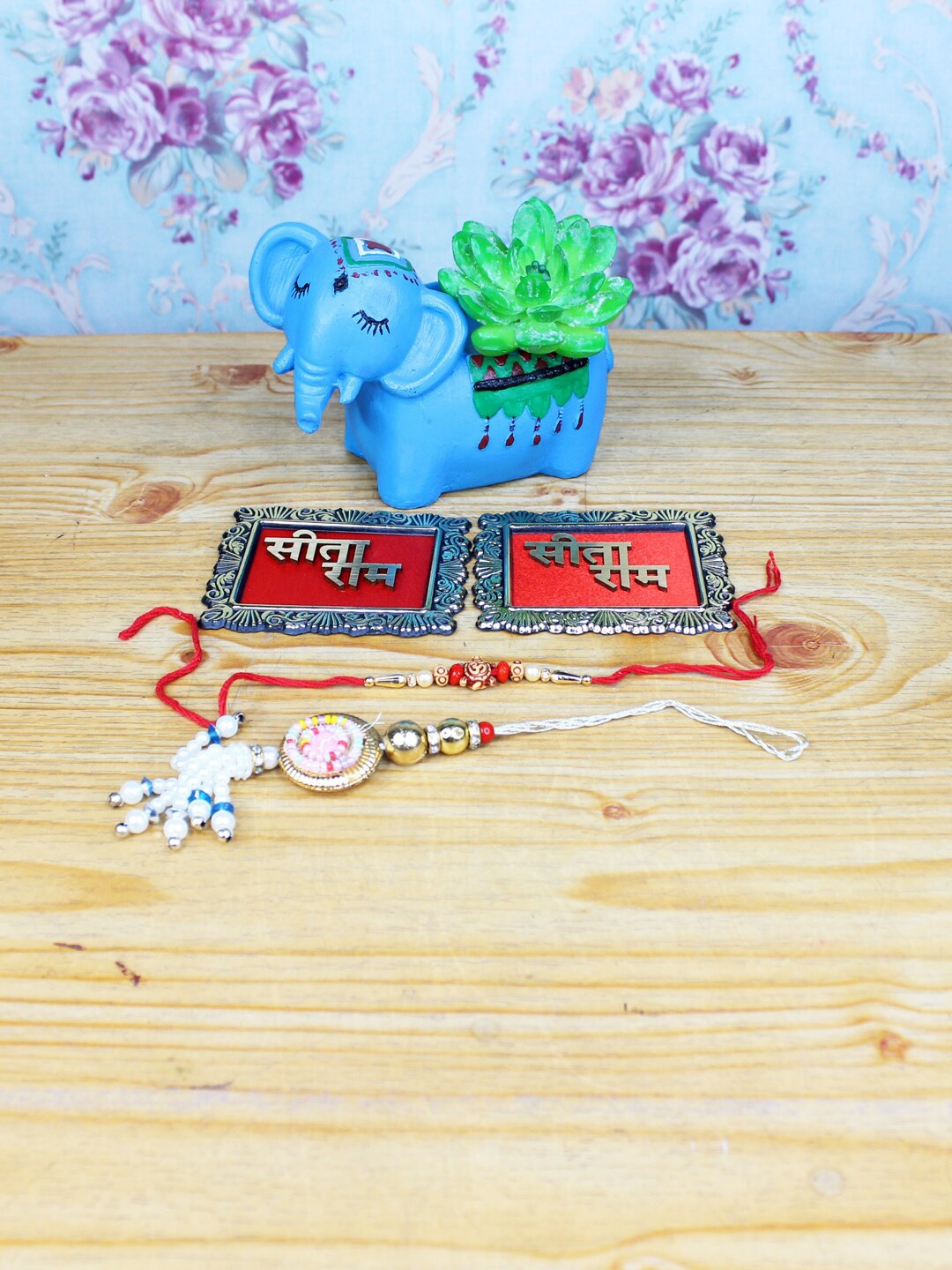 

Wonderland Blue & Red Set Of 2 Rakhi With Elephant Succulent Planter