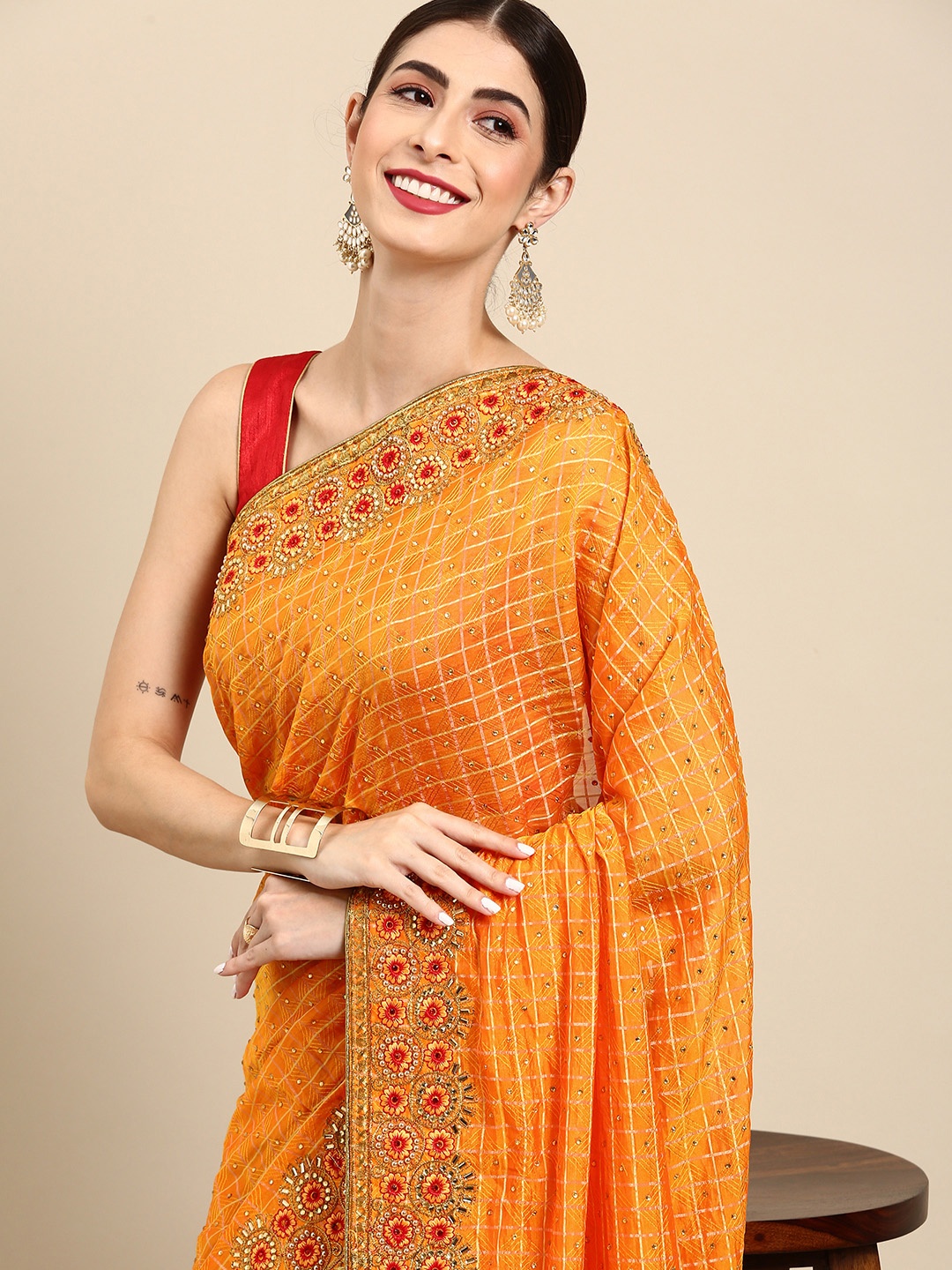 

Anouk Orange & Golden Self Checked Saree