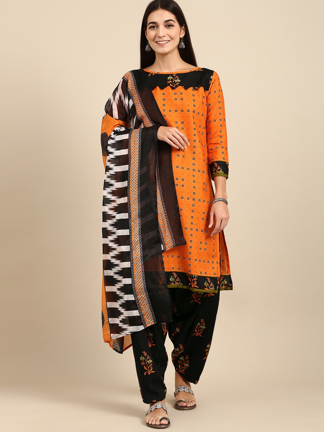 

Rajnandini Orange & Black Printed Unstitched Dress Material