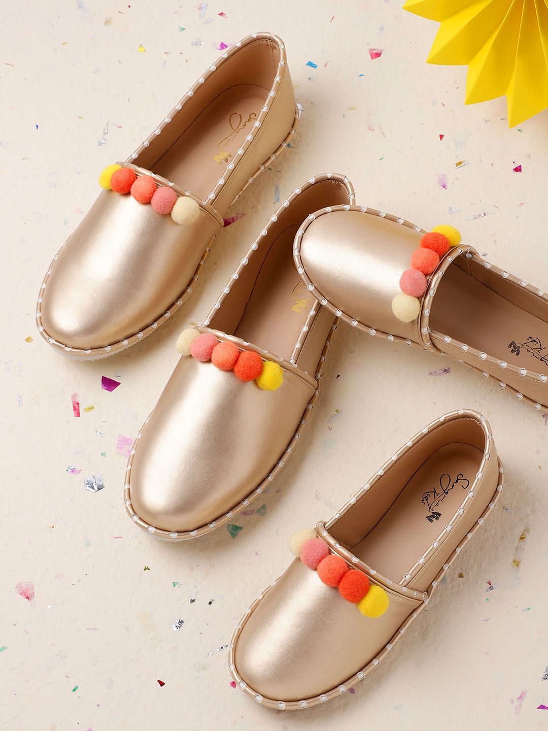

Sangria Women Muted Gold-Toned Solid Slip-Ons with Pom-Pom Detail