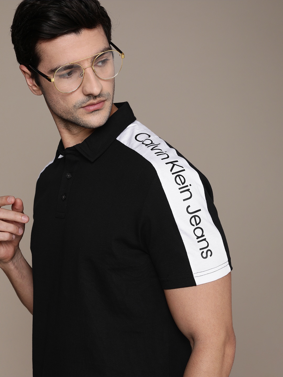 

Calvin Klein Jeans Men Black Solid Pure Cotton T-shirt With White Typography Sleeve Stripe
