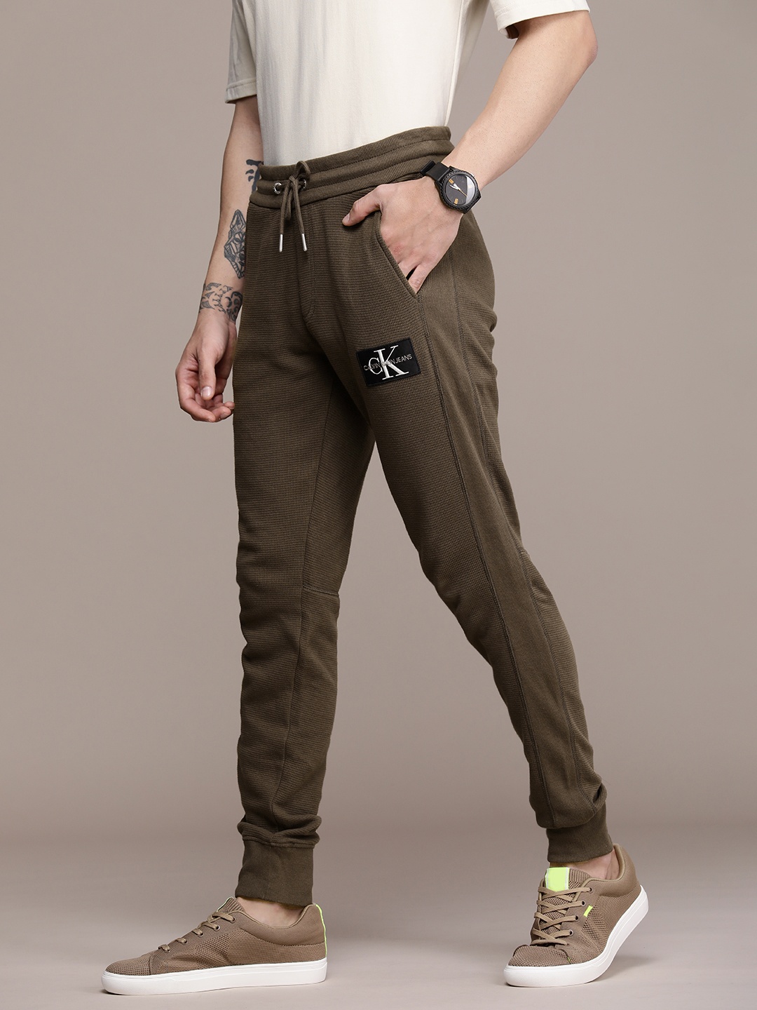 

Calvin Klein Jeans Men Olive Green Self Designed Pure Cotton Regular Fit Joggers