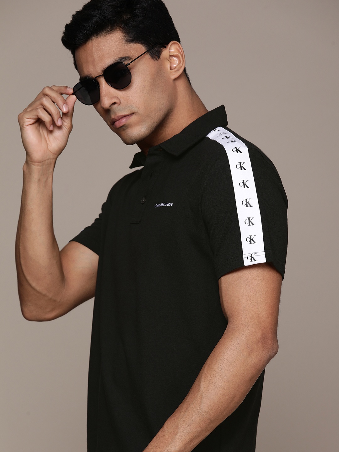 

Calvin Klein Jeans Men Black Solid Polo Collar Cotton T-shirt with Taping Detail
