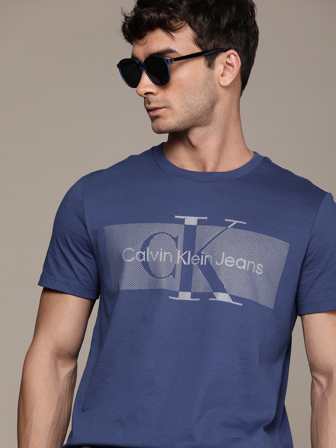 

Calvin Klein Jeans Men Blue & Silver-Toned Brand Logo Printed Pure Cotton T-shirt