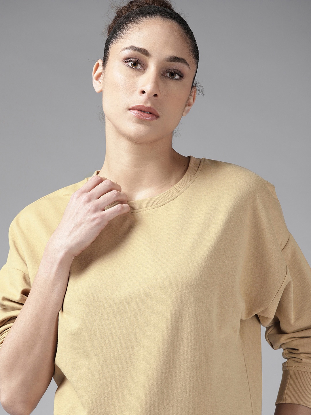 

Roadster Women Beige Drop-Shoulder Sleeves Solid Sweatshirt