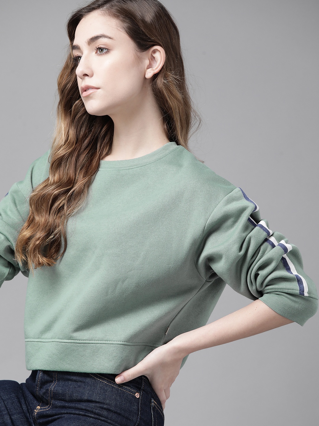 

Roadster Women Green Solid Sweatshirt