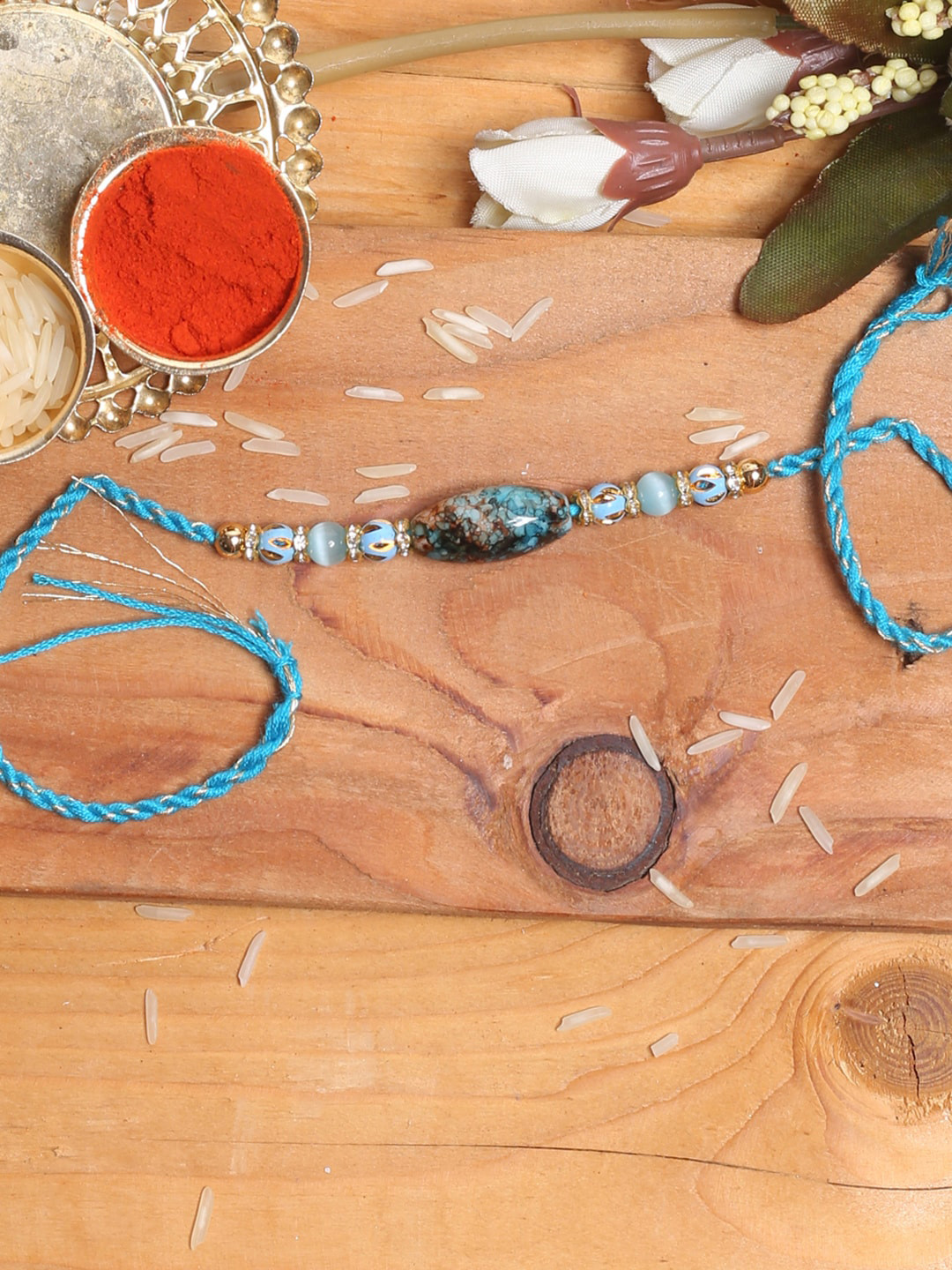 

Aapno Rajasthan Blue Marble Effect Rakhi With Tilak