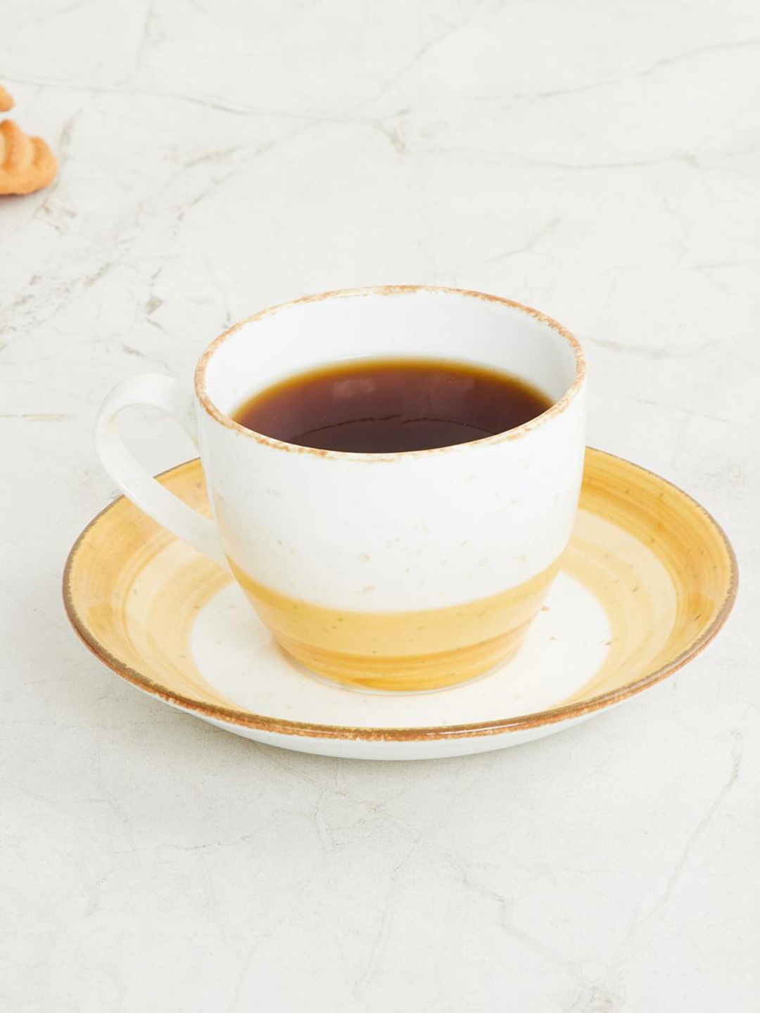 

Home Centre Brown & White Fiesta Printed Cup And Saucer Set