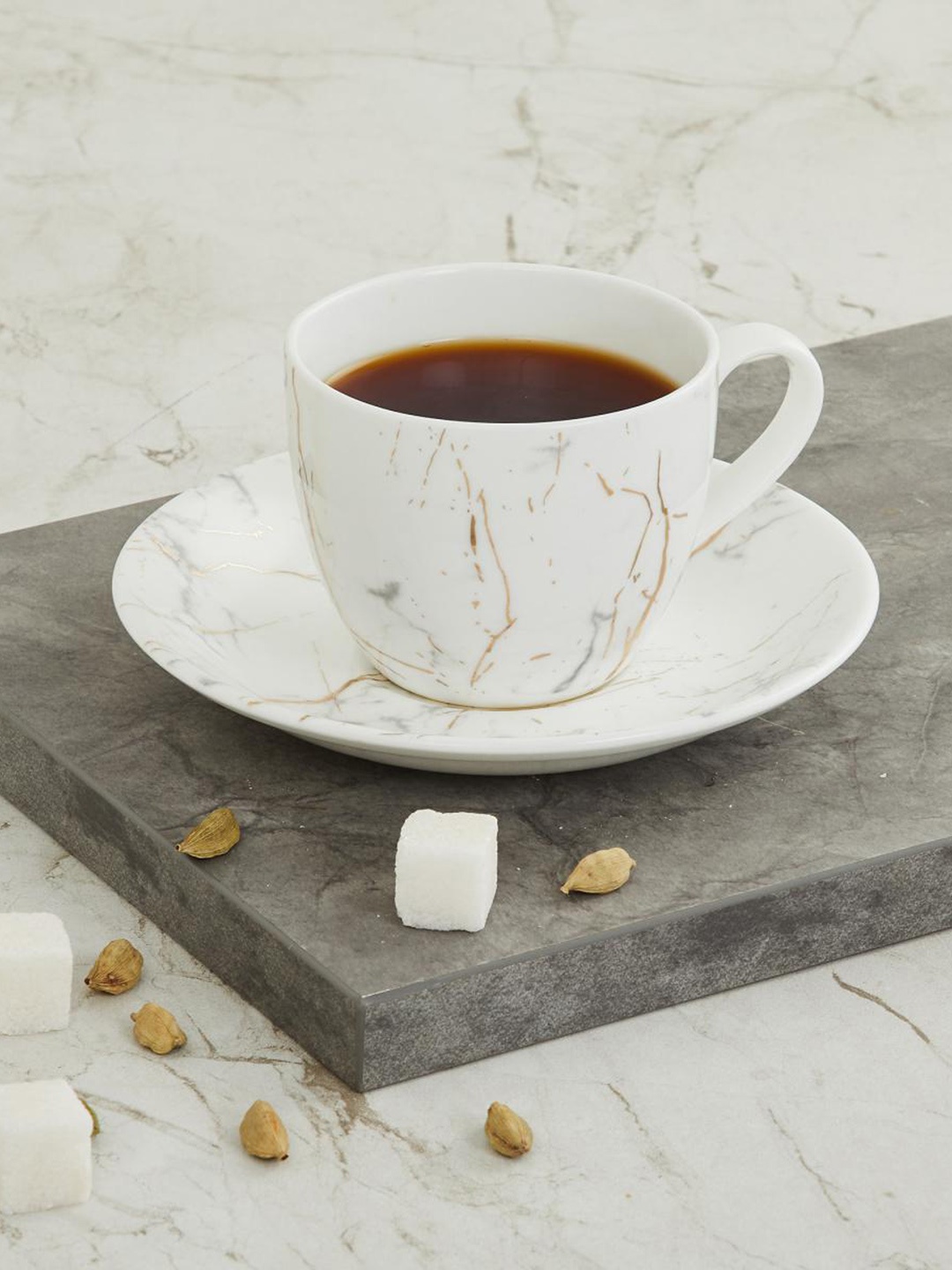 

Home Centre White Printed Marble Patterned Cup and Saucer Set