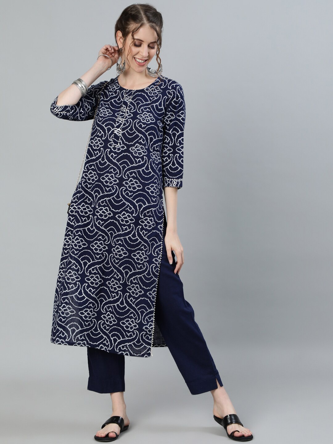 

Ishin Women Navy Blue Floral Printed Regular Mirror Work Pure Cotton Kurta with Trousers