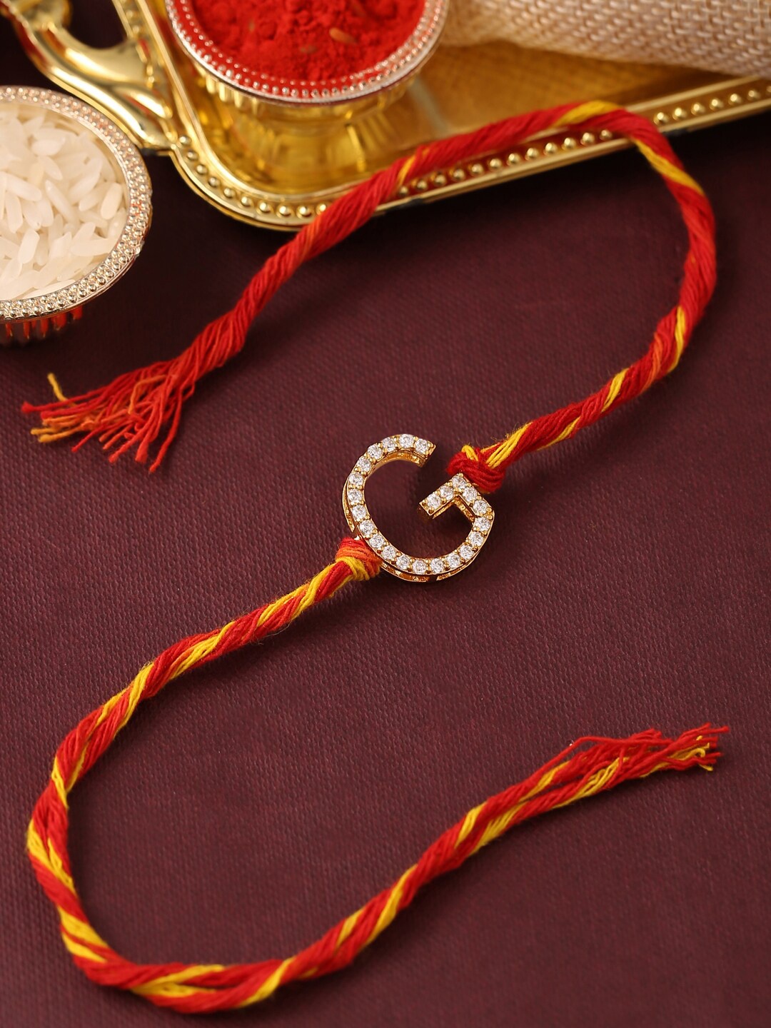 

Tistabene Men Red & White AD-Studded G Alphabet Rakhi