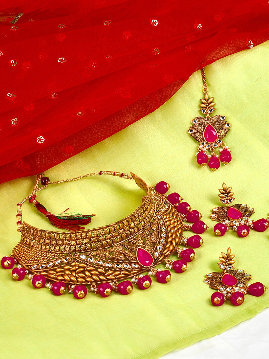 

Yellow Chimes Women Gold-Toned & Red Kundan Studded & Beaded Handcrafted Jewellery Set