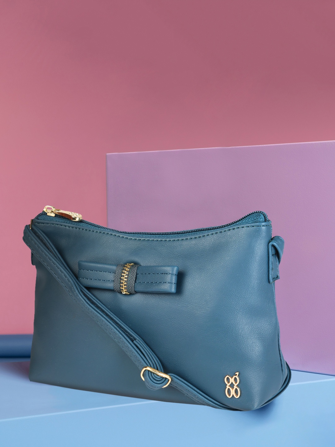 

Baggit Women Blue Solid Sling Bag With Bow Detail