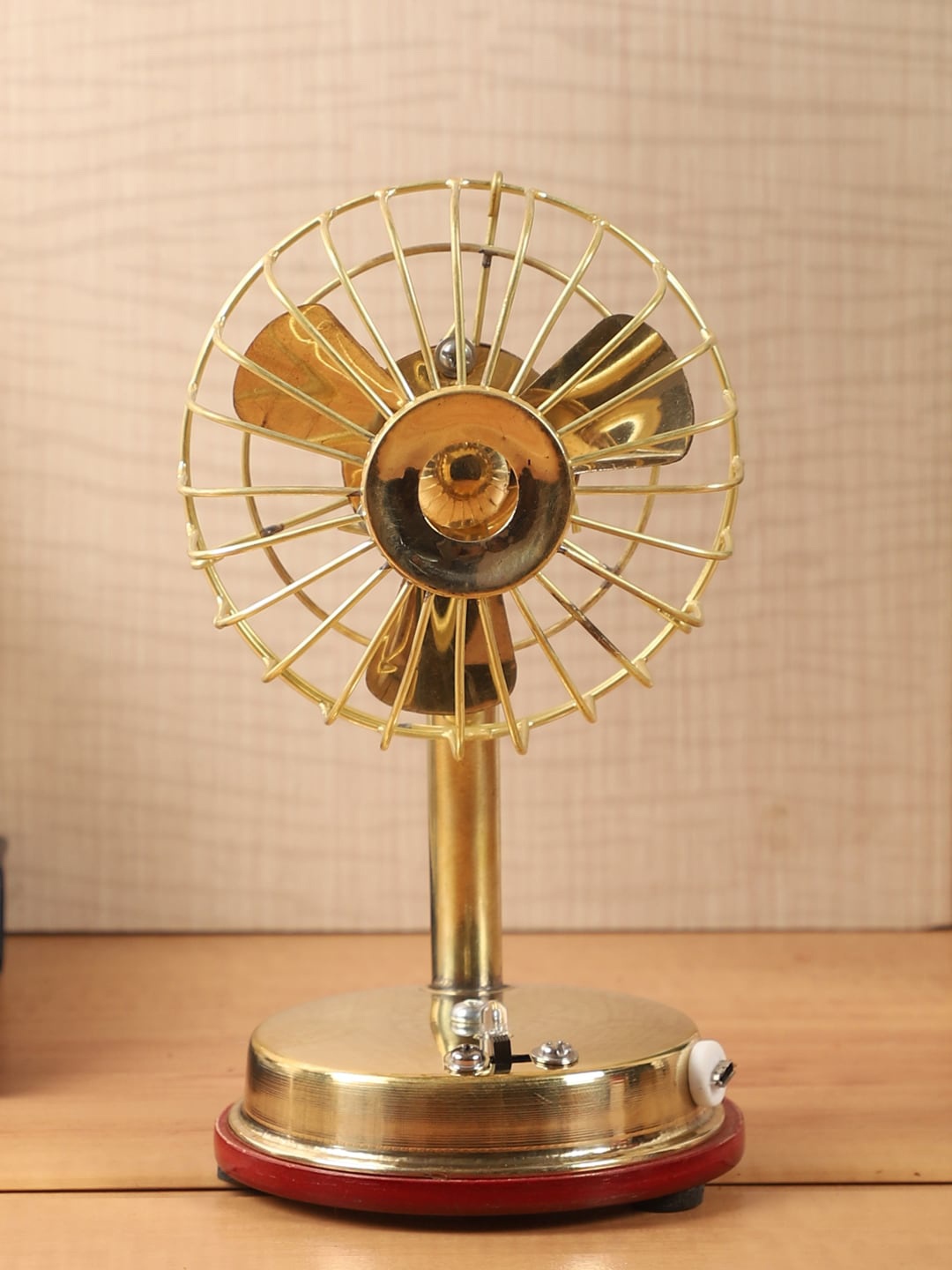 

EXIM DECOR Gold-Toned & Red Brass Fan Showpiece