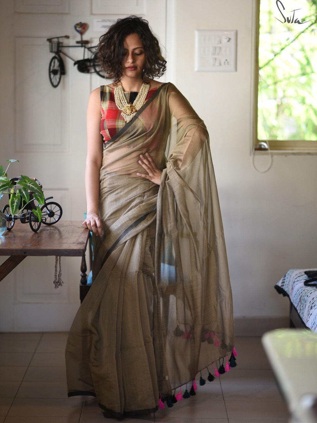 

Suta Brown with Pink & Black Tasseles Solid Sheer Saree