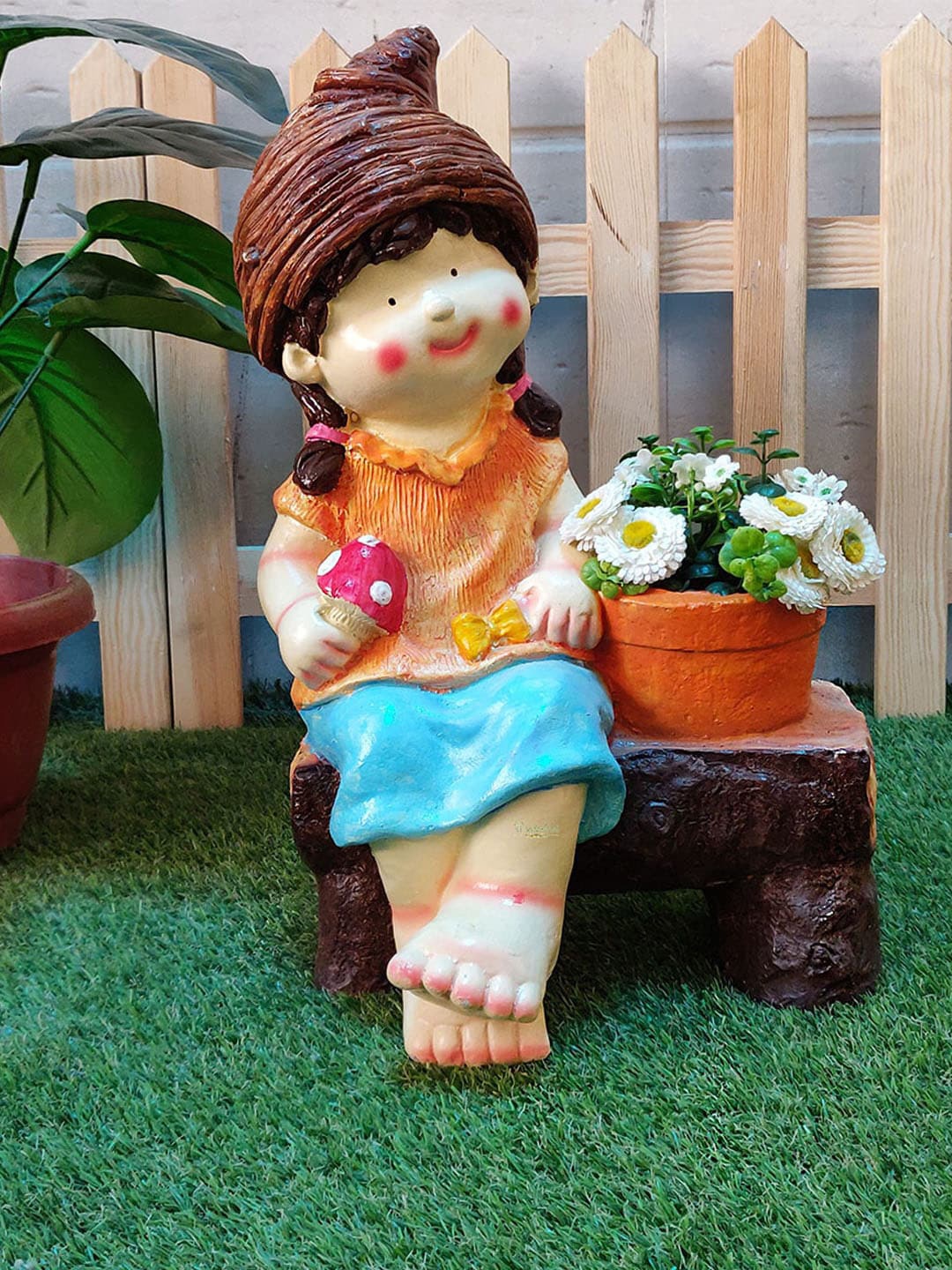 

Wonderland Orange & Brown Girl Sitting on Bench Pot