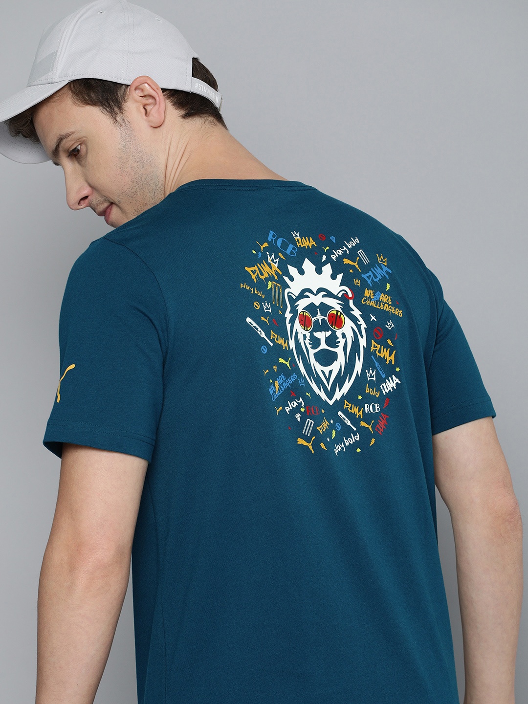 

Puma Men Teal Blue White RCB Graphic Printed Pure Cotton T-shirt