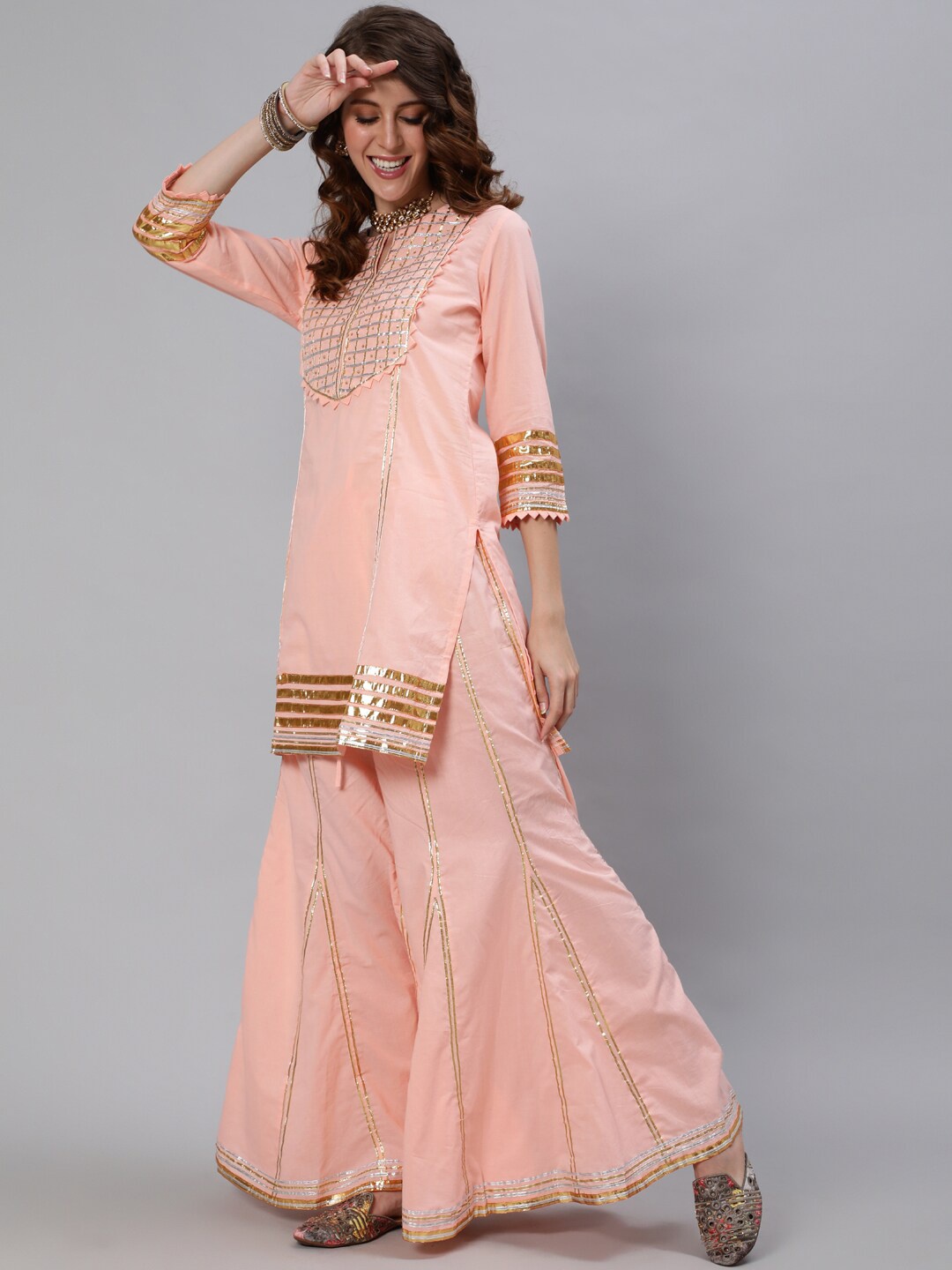 

Ishin Women Peach-Coloured Ethnic Motifs Yoke Design Panelled Pure Cotton Kurti with Sharara