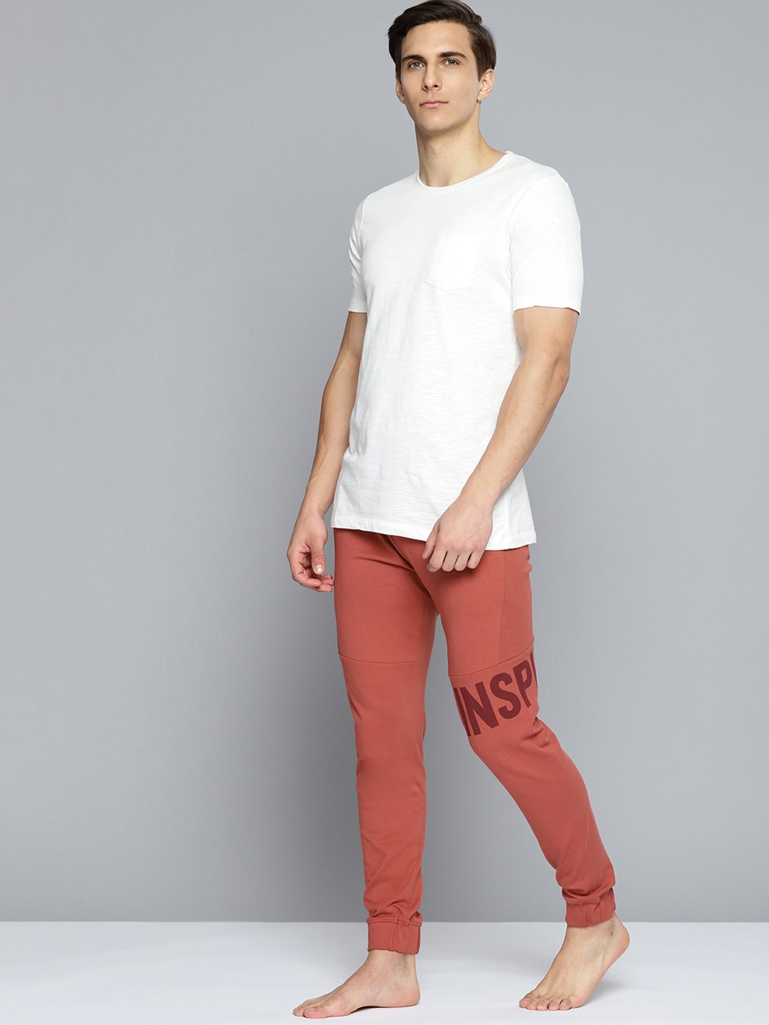 

HRX By Hrithik Roshan Yoga Men Tandoori Spice Rapid-Dry Typography Sustainable Track Pants, Rust