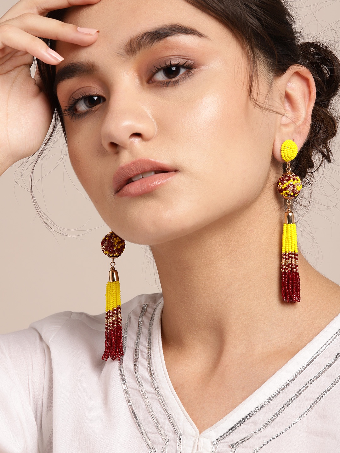 

Sangria Yellow & Maroon Beaded Spherical Tasseled Drop Earrings